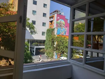 an open window with a view of a building at Nuevo y lujoso apartamento por el lleras (en el poblado ) in Medellín