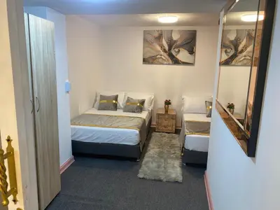 a small room with two beds and a mirror at Nuevo y lujoso apartamento por el lleras (en el poblado ) in Medellín